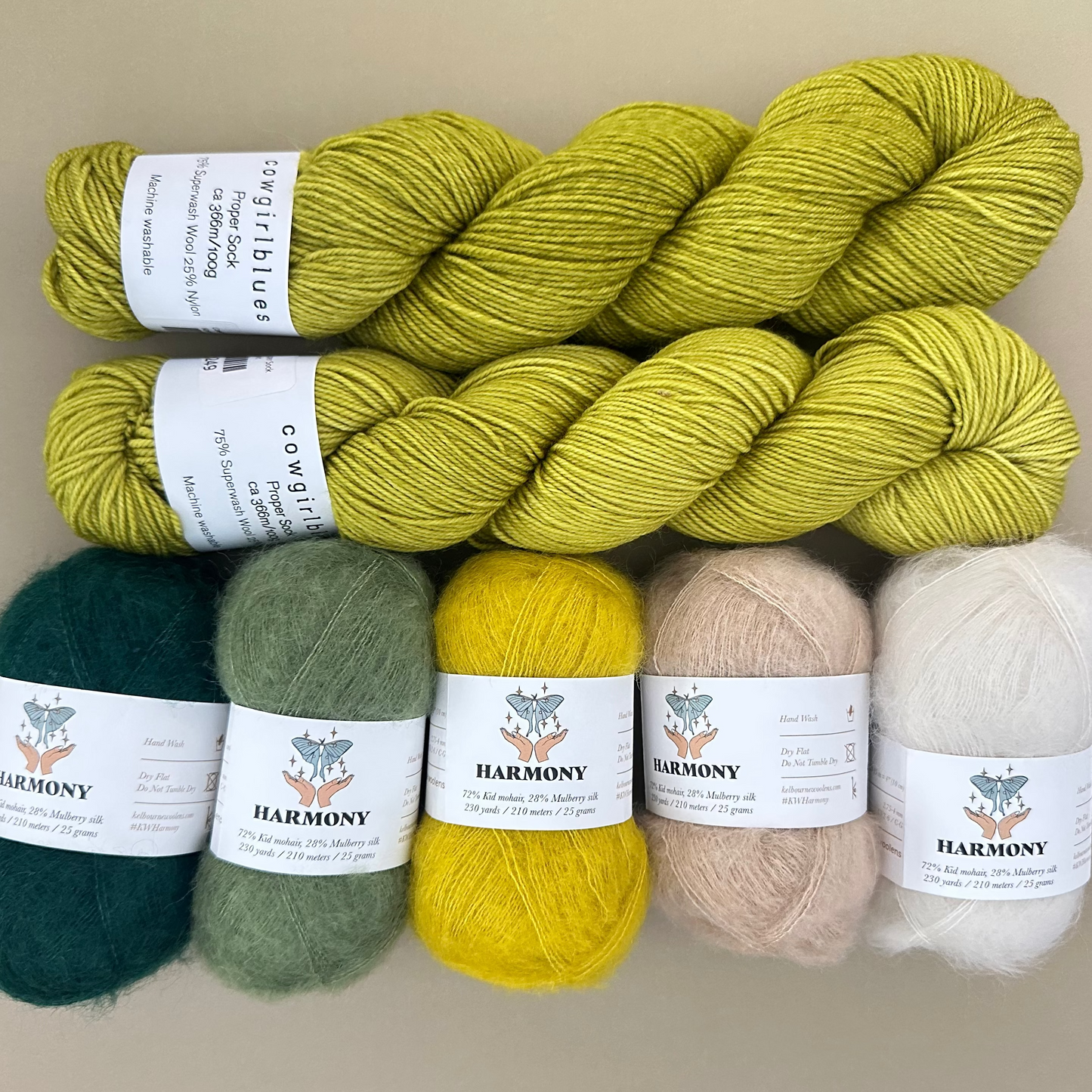 Set of colorful yarn skeins with labels on a neutral background