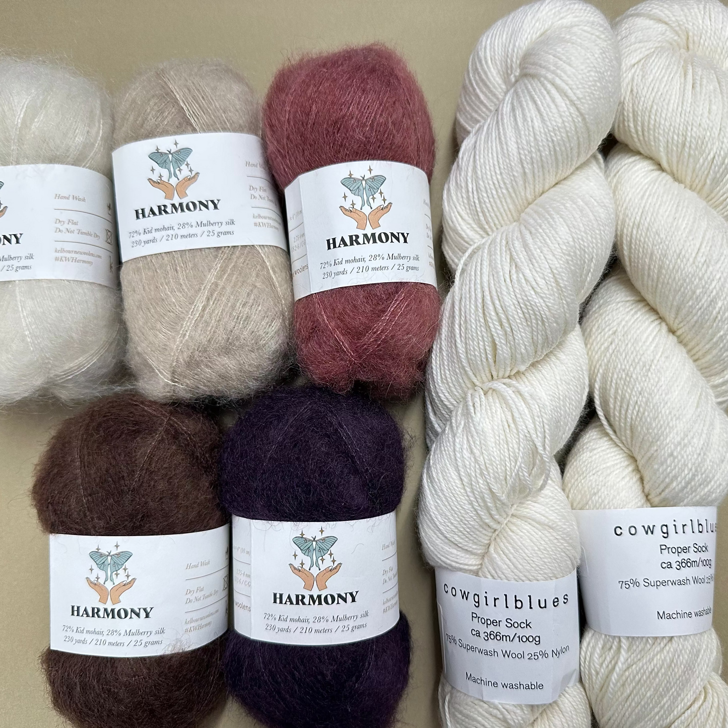 Set of yarn balls with labels on a beige background