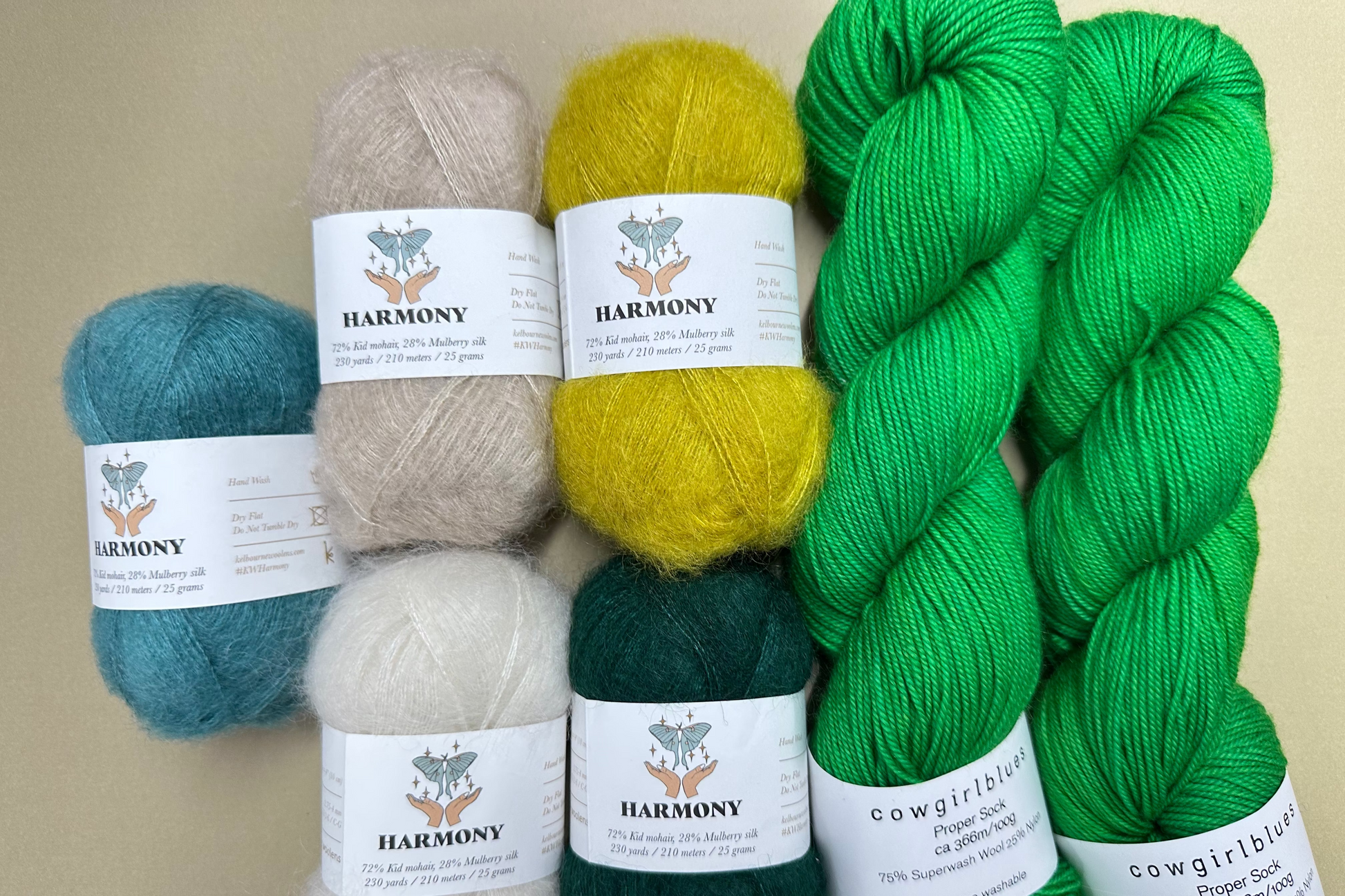 Collection of yarn balls with labels on a beige background